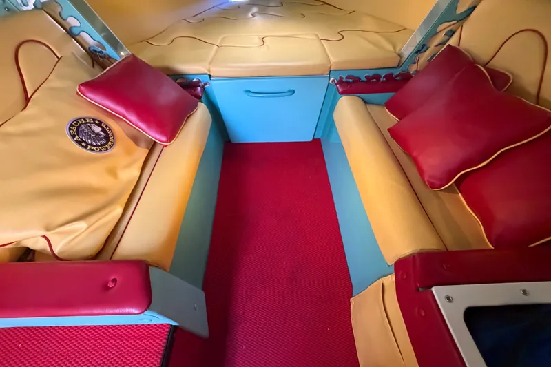 Slide: The Image of Interior of a 2011 Apache 28 Splash boat with vibrant seating and red carpet. - 45