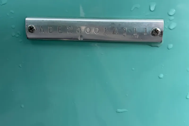 Slide: The Image of Serial number plate on turquoise Apache 28 Splash, 2011 model, with water droplets. - 101