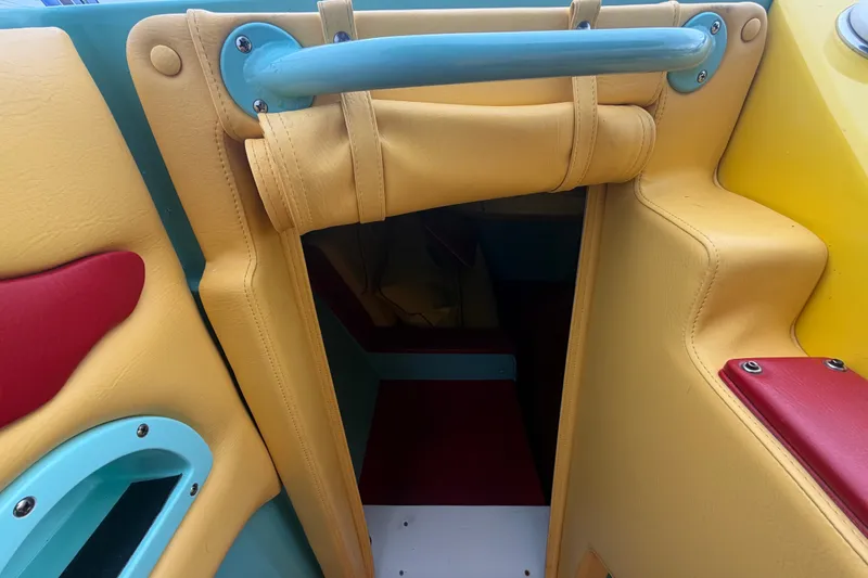 Slide: The Image of Colorful interior of a 2011 Apache 28 Splash boat, featuring vibrant upholstery. - 42