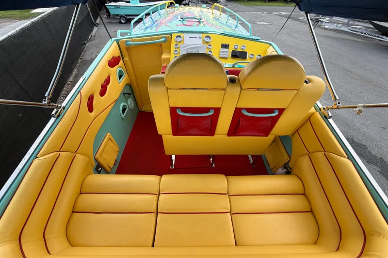Slide: The Image of Interior of a 2011 Apache 28 Splash boat with vibrant yellow and red seating. - 17