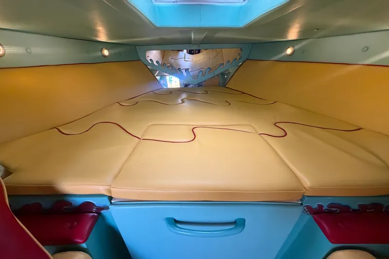 Slide: The Image of Interior cabin of a 2011 Apache 28 Splash boat with colorful seating and unique design. - 51