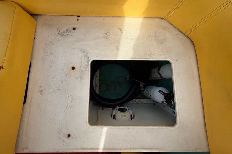 Slide: The Image of Interior view of a 2011 Apache 28 Splash boat, featuring a storage compartment. - 86