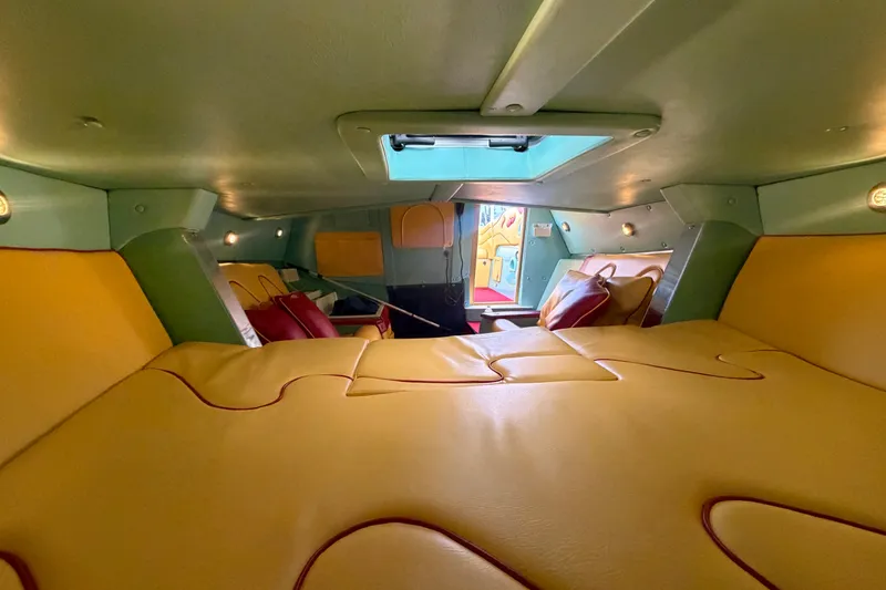 Slide: The Image of Interior of 2011 Apache 28 Splash boat with yellow and red seating. - 54