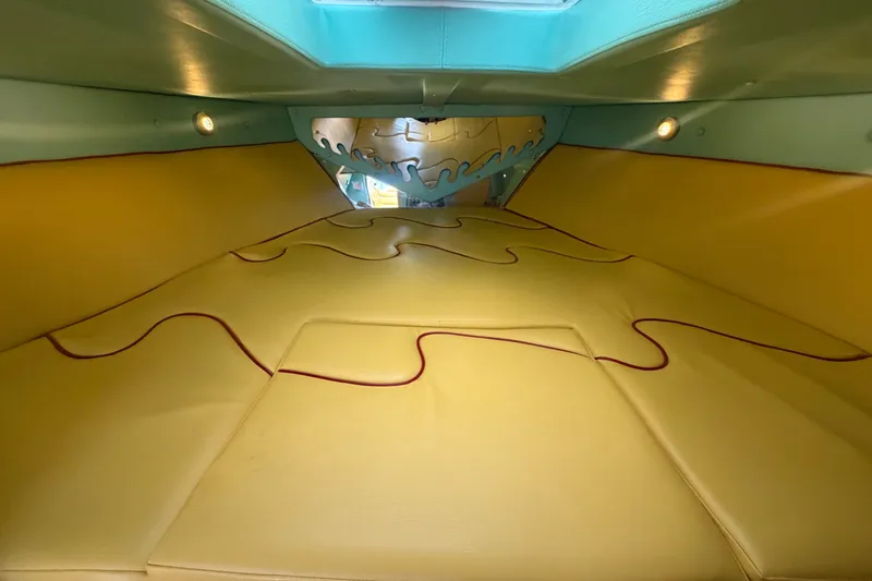 Slide: The Image of Interior of 2011 Apache 28 Splash boat with yellow cushioned seating and wave design. - 53