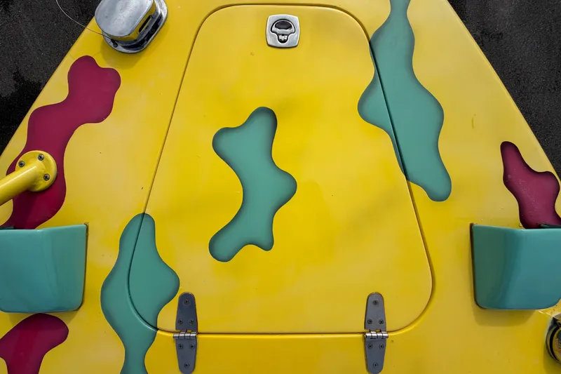 Slide: The Image of Colorful Apache 28 Splash boat deck, 2011 model, featuring vibrant yellow, teal, and red patterns. - 72