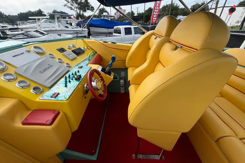 Slide: The Image of Interior of 2011 Apache 28 Splash boat with yellow seats and control panel. - 21