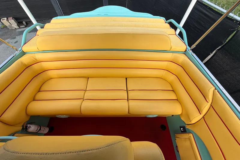 Slide: The Image of Yellow and red seating in a 2011 Apache 28 Splash boat interior. - 80