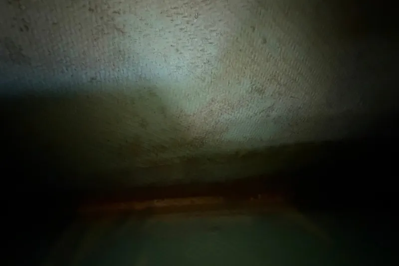 Slide: The Image of Dimly lit interior of a 2011 Apache 28 Splash boat, showing textured surface. - 60