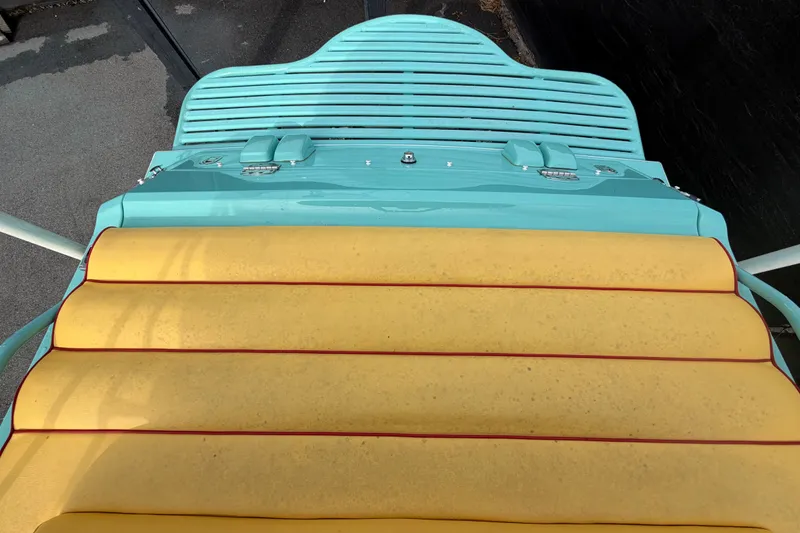 Slide: The Image of Colorful deck of a 2011 Apache 28 Splash boat with yellow and turquoise accents. - 99
