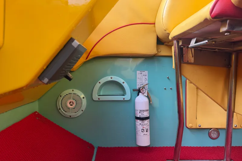 Slide: The Image of Interior of 2011 Apache 28 Splash boat with colorful seating and safety equipment. - 39