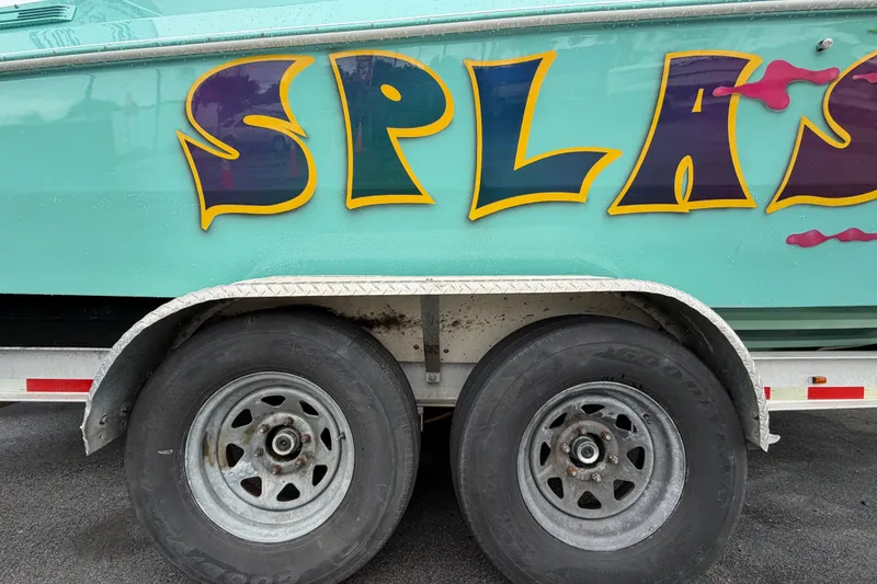 Slide: The Image of Trailer with Apache 28 Splash boat, vibrant lettering, and dual wheels, 2011 model. - 104