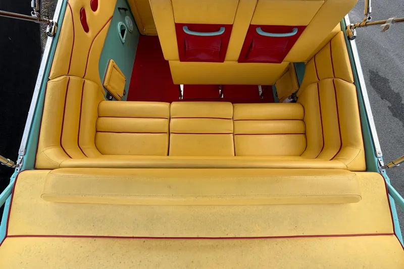 Slide: The Image of Yellow and red interior of a 2011 Apache 28 Splash boat, featuring cushioned seating. - 16