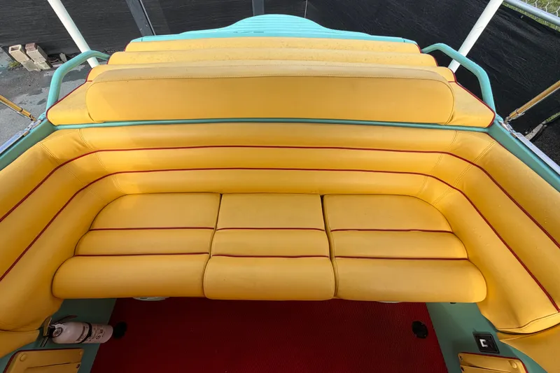 Slide: The Image of Yellow seating on a 2011 Apache 28 Splash boat with red accents. - 83