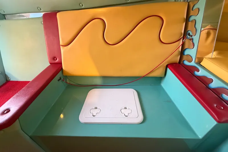 Slide: The Image of Colorful interior seating of a 2011 Apache 28 Splash boat with vibrant upholstery. - 49