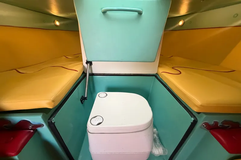 Slide: The Image of Interior of 2011 Apache 28 Splash boat with yellow seating and compact toilet. - 52