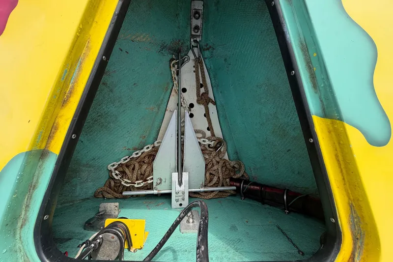 Slide: The Image of Anchor compartment of 2011 Apache 28 Splash boat with chain and equipment. - 74
