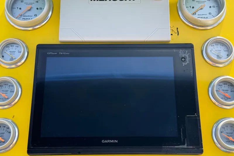 Slide: The Image of Dashboard of a 2011 Apache 28 Splash boat with Garmin GPS and gauges. - 27