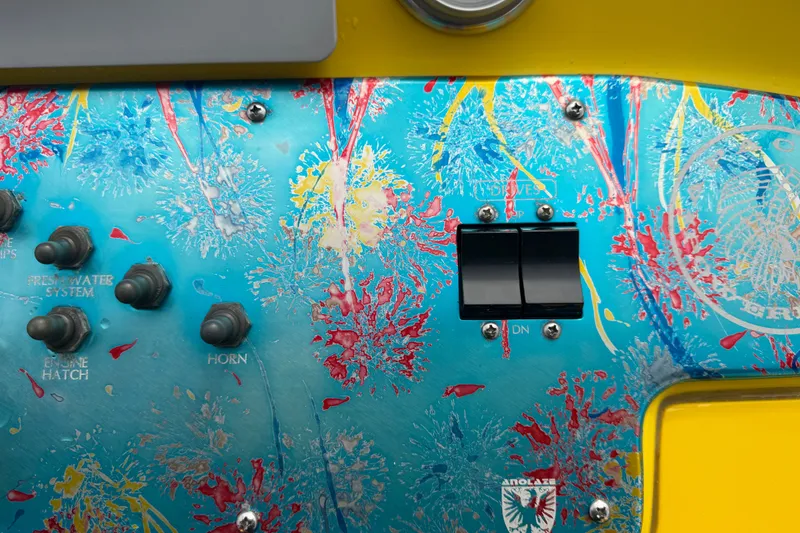 Slide: The Image of Colorful control panel of a 2011 Apache 28 Splash boat with switches and artistic design. - 36
