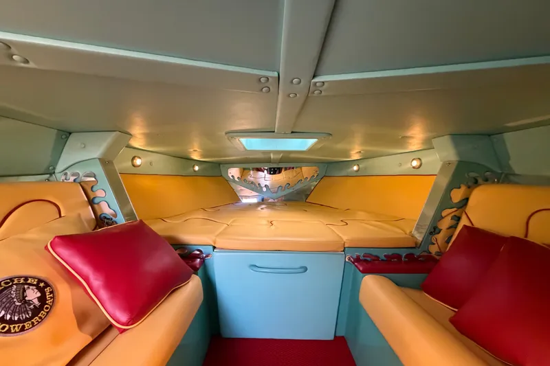 Slide: The Image of Interior of a 2011 Apache 28 Splash boat with vibrant seating and cozy cabin design. - 46