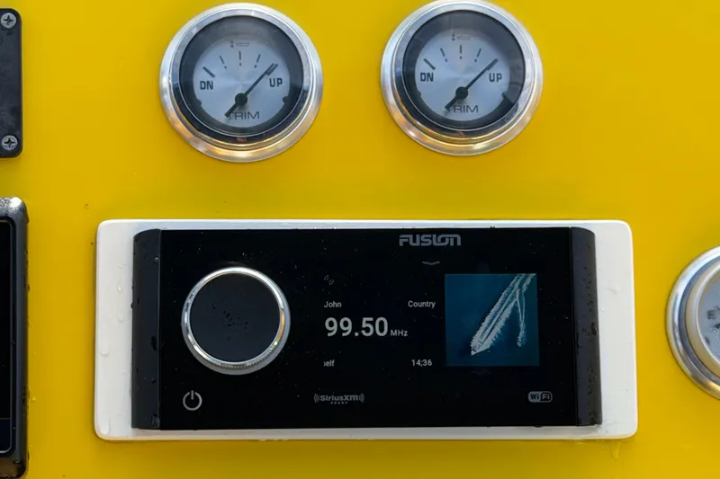 Slide: The Image of Yellow dashboard of 2011 Apache 28 Splash with gauges and Fusion radio display. - 31