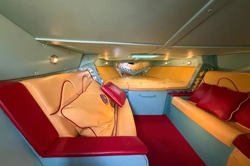 Slide: The Image of Interior of 2011 Apache 28 Splash boat with red and yellow seating, cozy cabin design. - 44