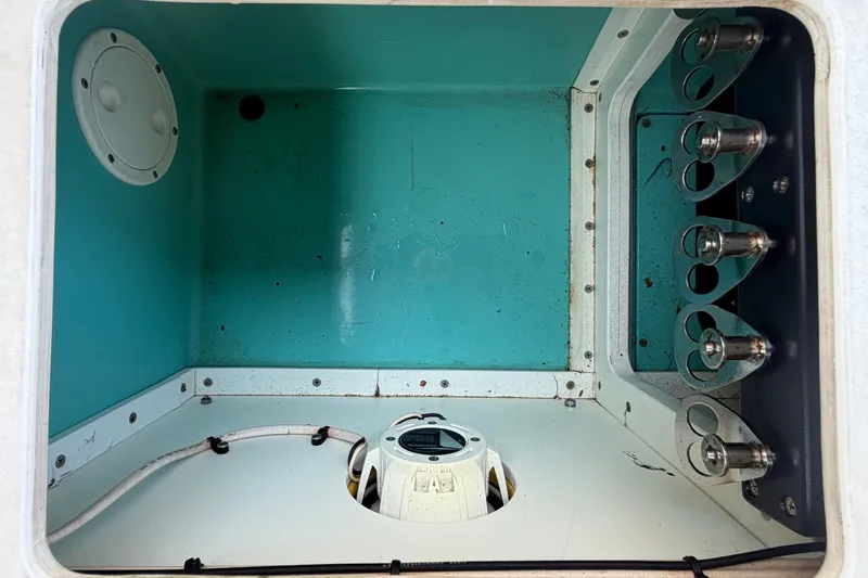 Slide: The Image of Interior view of a 2011 Apache 28 Splash boat compartment with wiring and fixtures. - 93