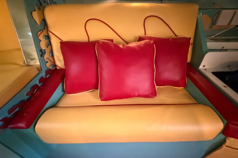 Slide: The Image of Yellow and red cushioned seating inside a 2011 Apache 28 Splash boat. - 57