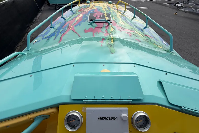 Slide: The Image of Colorful 2011 Apache 28 Splash boat with vibrant design and Mercury gauges. - 68