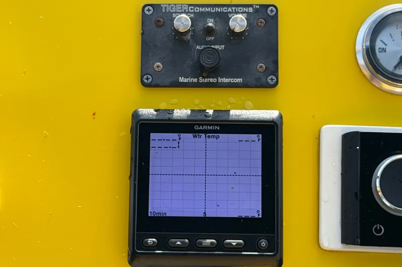 Slide: The Image of Control panel of a 2011 Apache 28 Splash boat with Garmin display and intercom. - 30