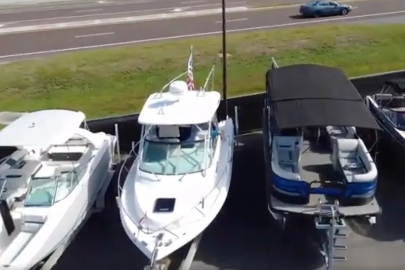 The Image of 2011 Apache 28 Splash boat docked between two other boats, aerial view. - 1