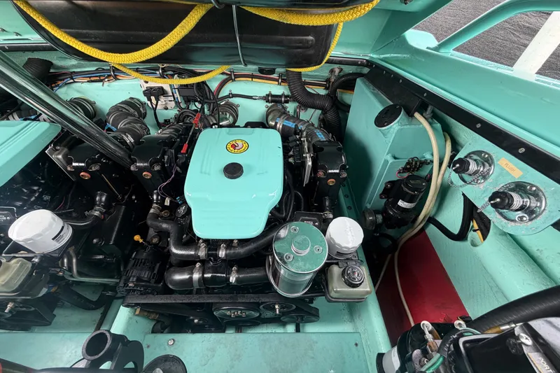 Slide: The Image of Engine compartment of a 2011 Apache 28 Splash boat, showcasing detailed mechanical components. - 98