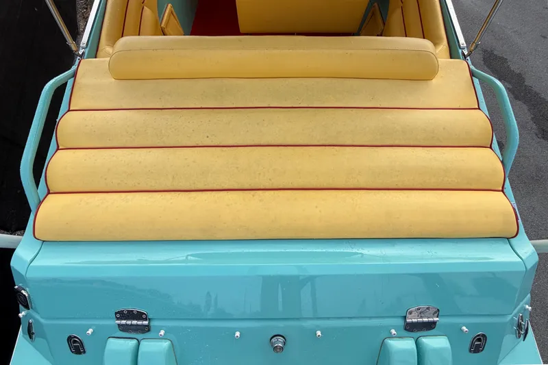 Slide: The Image of Rear view of a 2011 Apache 28 Splash boat with yellow upholstery and turquoise hull. - 15