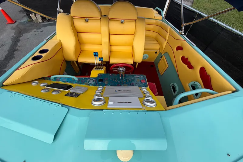 Slide: The Image of Colorful interior of a 2011 Apache 28 Splash boat with vibrant yellow seating. - 77
