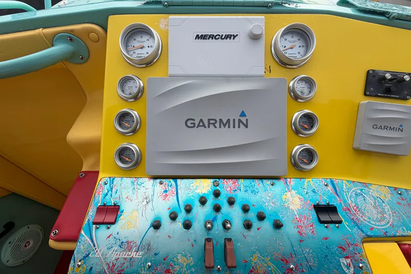 Slide: The Image of Colorful dashboard of a 2011 Apache 28 Splash boat with Garmin and Mercury instruments. - 24