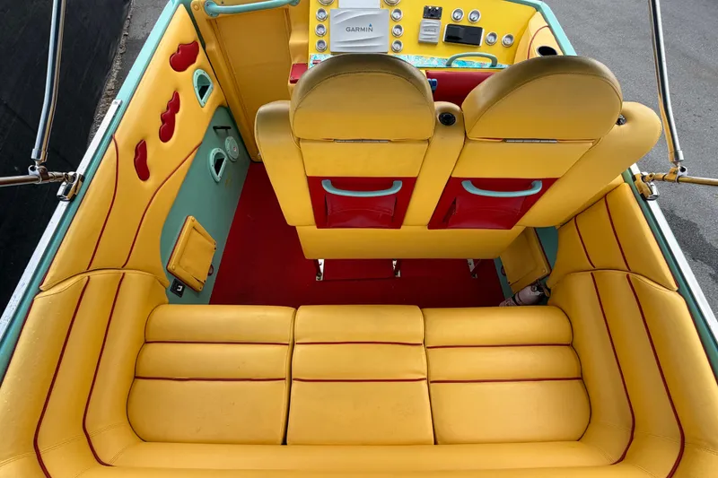 Slide: The Image of Interior of a 2011 Apache 28 Splash boat with vibrant yellow and red seating. - 18