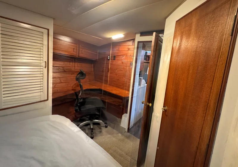 Slide: The Image of The image shows a cozy cabin with wooden walls and a desk chair. A door leads to another room. - 47