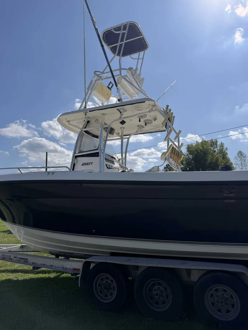 Slide: The Image of A 2006 Century 2900 Center Console boat on a trailer, featuring an elevated helm station. - 4