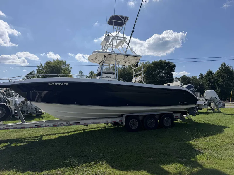Slide: The Image of A 2006 Century 2900 Center Console boat on a trailer outdoors. - 1