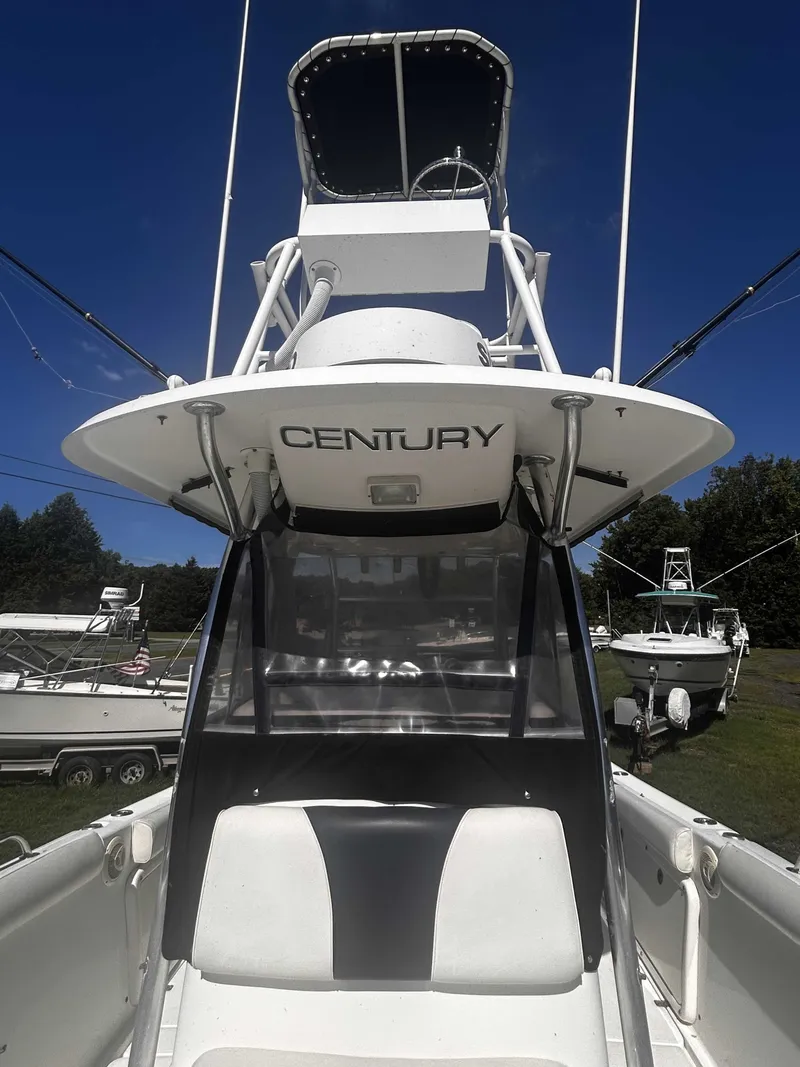 Slide: The Image of A 2006 Century 2900 Center Console boat with elevated helm and clear view enclosure. - 7