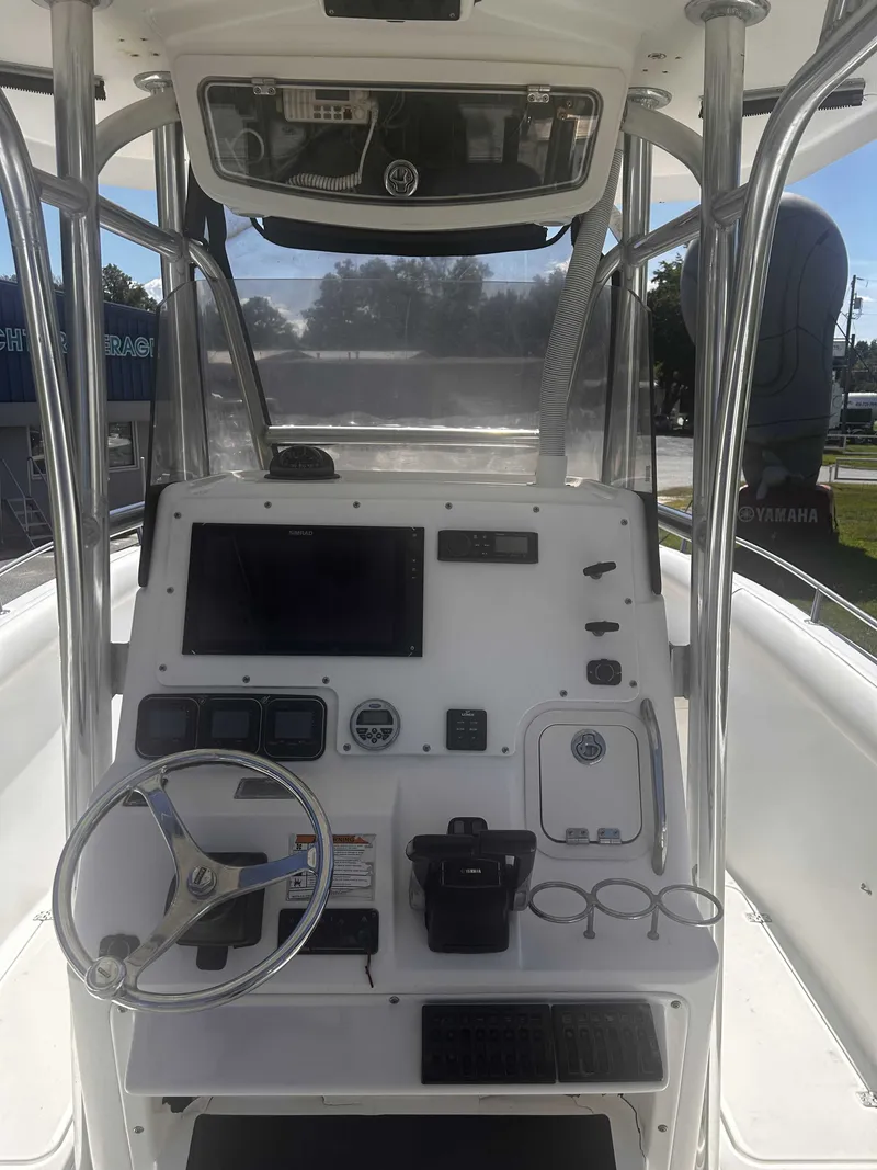 Slide: The Image of The image shows the helm of a 2006 Century 2900 Center Console boat with modern instruments. - 6
