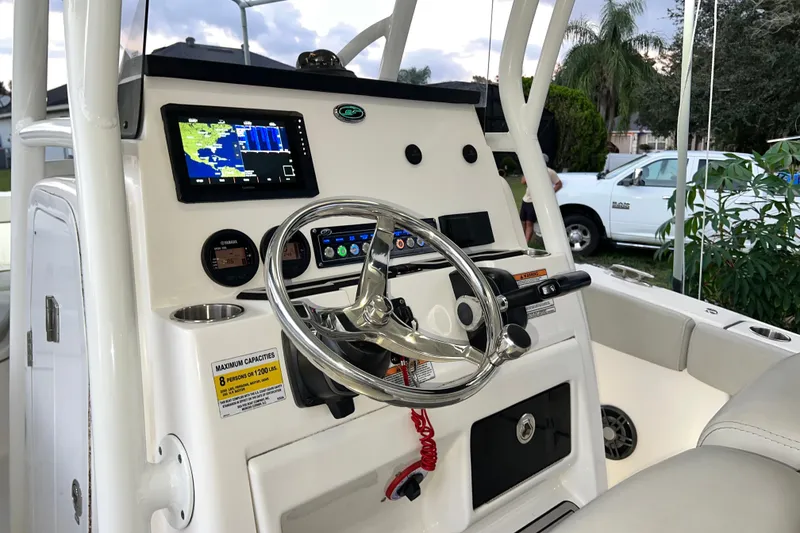 Slide: The Image of 2024 Sea Fox 228 Commander boat dashboard with steering wheel and navigation display. - 24