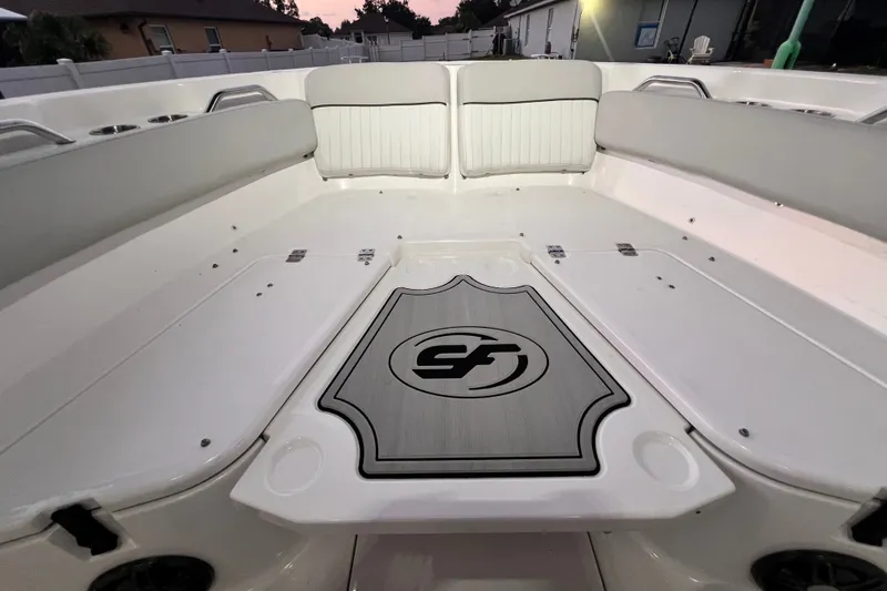 Slide: The Image of 2024 Sea Fox 228 Commander boat interior with cushioned seating and logo detail. - 59
