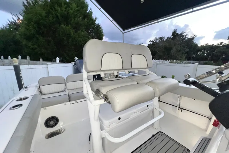 Slide: The Image of 2024 Sea Fox 228 Commander boat interior with cushioned seating and steering console. - 32