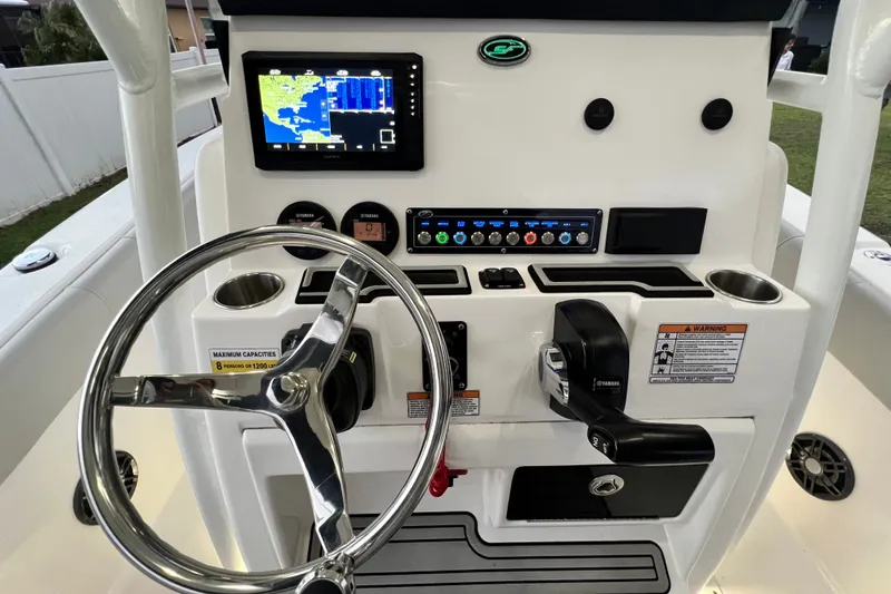 Slide: The Image of 2024 Sea Fox 228 Commander boat dashboard with steering wheel and navigation display. - 39