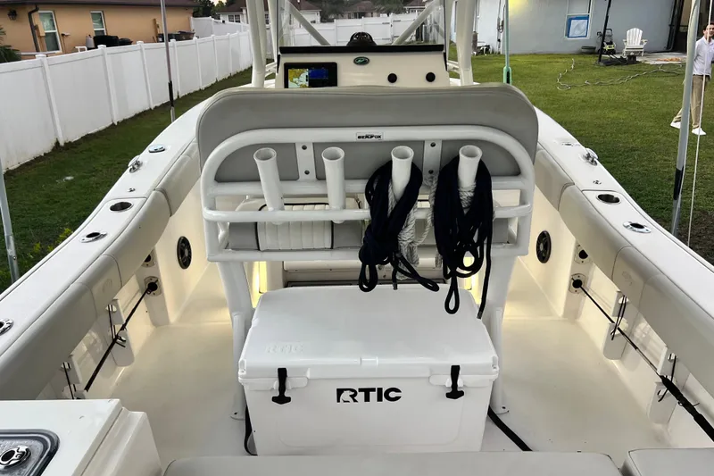 Slide: The Image of 2024 Sea Fox 228 Commander boat interior with rod holders and RTIC cooler. - 12