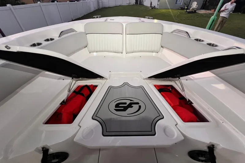 Slide: The Image of 2024 Sea Fox 228 Commander boat interior with open storage compartments and seating. - 60