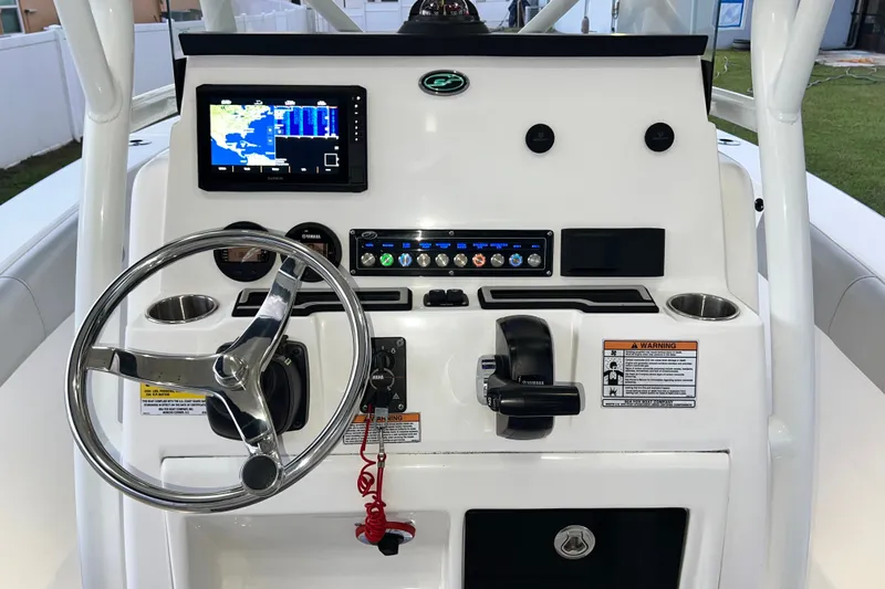 Slide: The Image of 2024 Sea Fox 228 Commander boat dashboard with steering wheel and navigation display. - 21