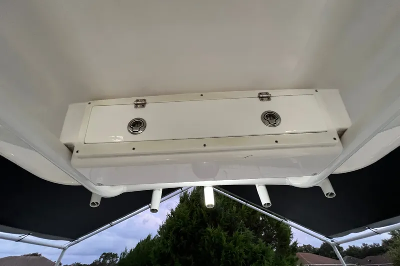 Slide: The Image of 2024 Sea Fox 228 Commander boat storage compartment with rod holders, viewed from below. - 51