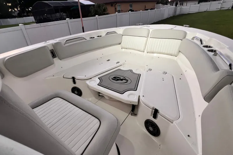 Slide: The Image of 2024 Sea Fox 228 Commander boat interior with cushioned seating and storage compartments. - 57