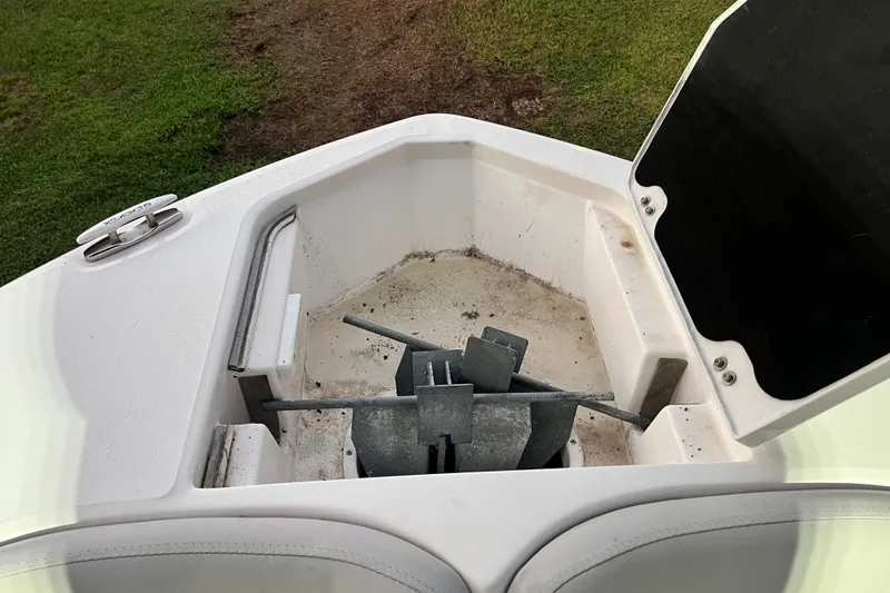 Slide: The Image of 2024 Sea Fox 228 Commander anchor storage compartment with open hatch, showcasing anchor setup. - 62